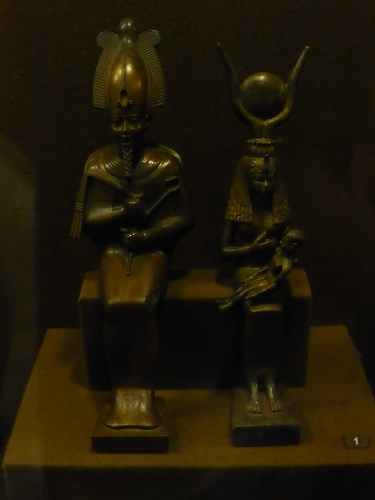 Bronze statuettes of Osiris and Isis with Horus on her lap in the Room of Ancient Egypt at the Ground Floor of the Winter Palace of the State Hermitage Museum