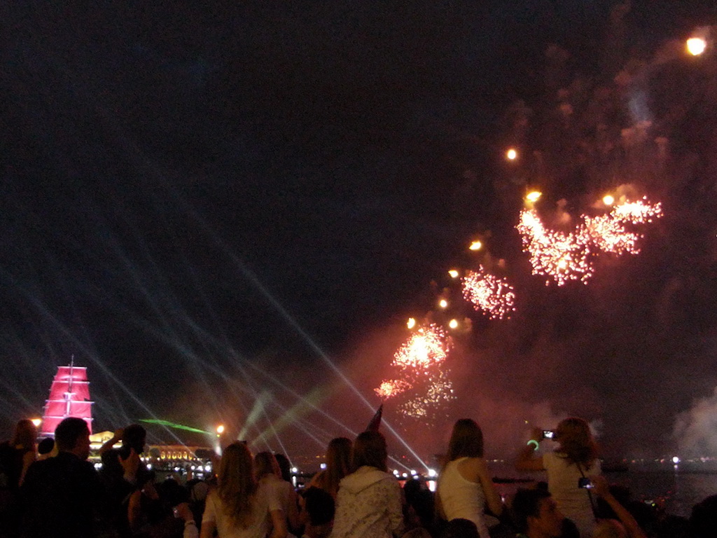 The Shtandart frigate in the Neva river and fireworks during the Scarlet Sails celebration at the Dvortsovaya street, by night