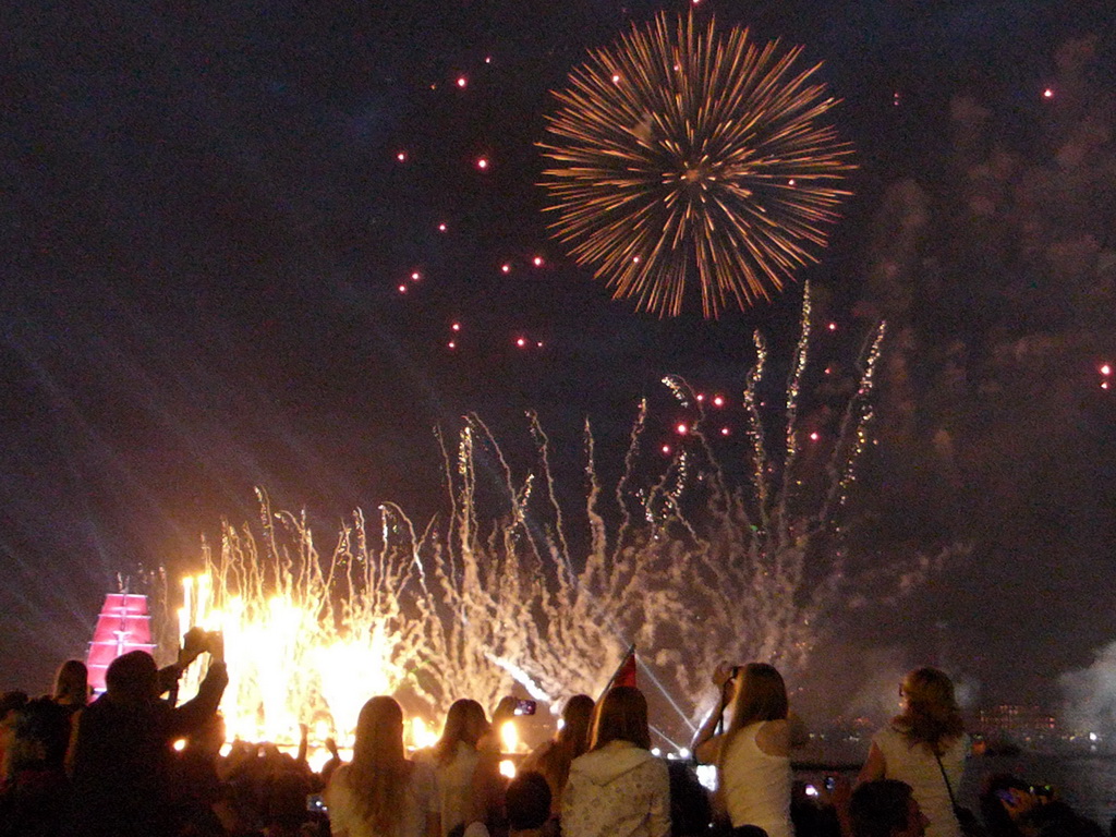 The Shtandart frigate in the Neva river and fireworks during the Scarlet Sails celebration at the Dvortsovaya street, by night