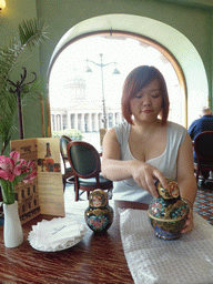 Miaomiao with a set of Matryoshka dolls at Cafe Singer at the Nevskiy Prospekt street, with a view on the Kazan Cathedral