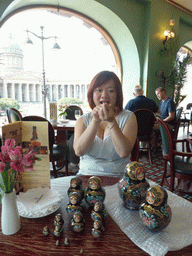 Miaomiao with a set of Matryoshka dolls at Cafe Singer at the Nevskiy Prospekt street, with a view on the Kazan Cathedral