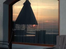 Window in a house at the beach at the Ocean Front Walk, at sunset