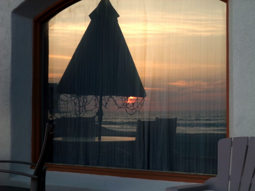 Window in a house at the beach at the Ocean Front Walk, at sunset