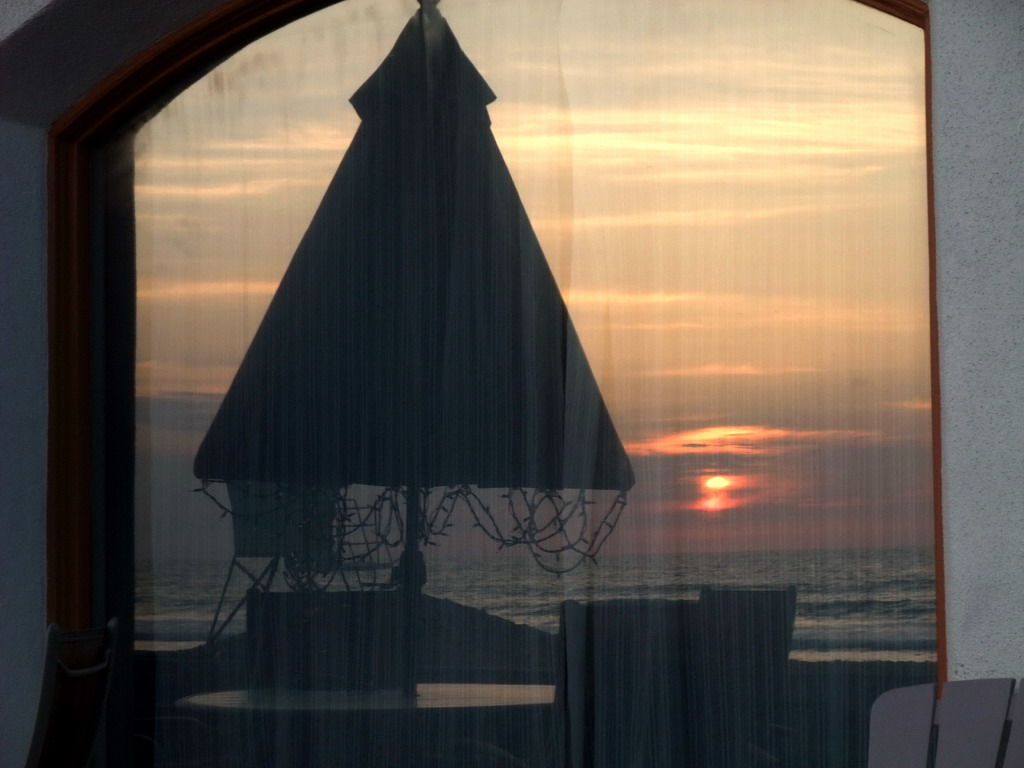Window in a house at the beach at the Ocean Front Walk, at sunset