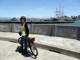 Mengjin with bike, and boats in San Francisco Bay and the skyline of San Francisco