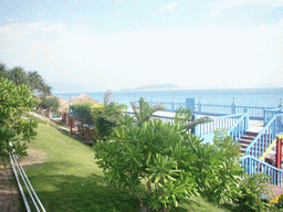 The beach of Yalong Bay with the top of the beach shack of Gloria Resort Sanya