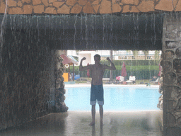 Tim under a waterfall at the swimming pool at the Gloria Resort Sanya