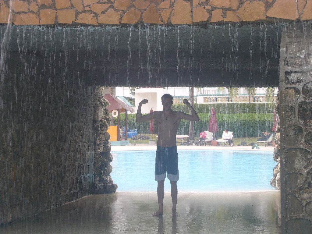 Tim under a waterfall at the swimming pool at the Gloria Resort Sanya