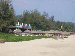 Lounge chairs and umbrellas at another hotel at the beach of Yalong Bay