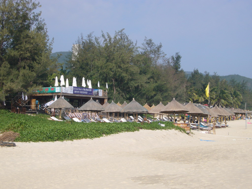 Lounge chairs and umbrellas at another hotel at the beach of Yalong Bay