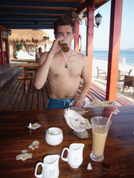 Tim having a drink at the beach shack of Gloria Resort Sanya