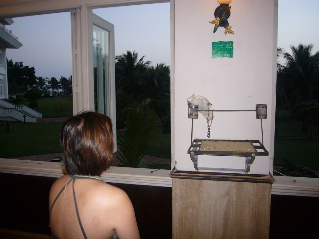 Miaomiao with a parrot in the lobby of the Gloria Resort Sanya