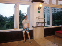 Tim with a parrot in the lobby of the Gloria Resort Sanya