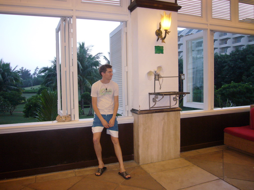 Tim with a parrot in the lobby of the Gloria Resort Sanya