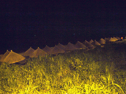 Umbrellas at the beach of Yalong Bay, by night