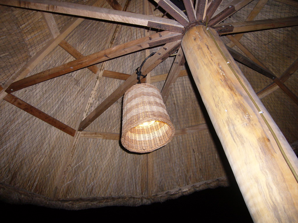 Umbrella with a lamp at the beach of Yalong Bay, by night