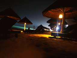 Umbrella with lamps at the beach of Yalong Bay, by night