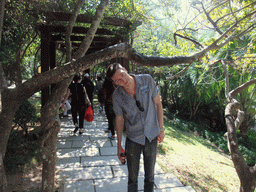 Tim under a tree branch at the Sanya Nanshan Dongtian Park
