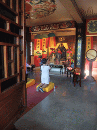 People praying in the Buddhist temple at the Temporary Palace of the Dragon King of the South Sea at the Sanya Nanshan Dongtian Park