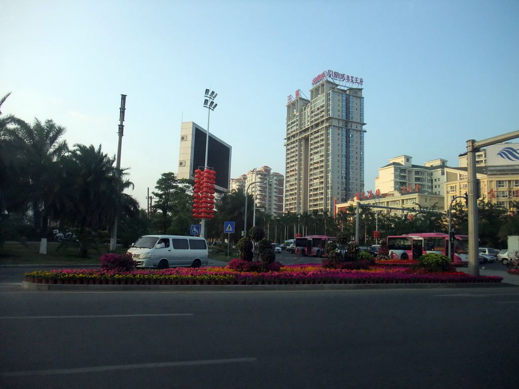 Flowers and apartment buildings in the Yuechuan district, viewed from a car