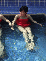 Mengjin with little fish in the Dr. Fish pool at the Fisherman`s Wharf at the Ocean Sonic Resort