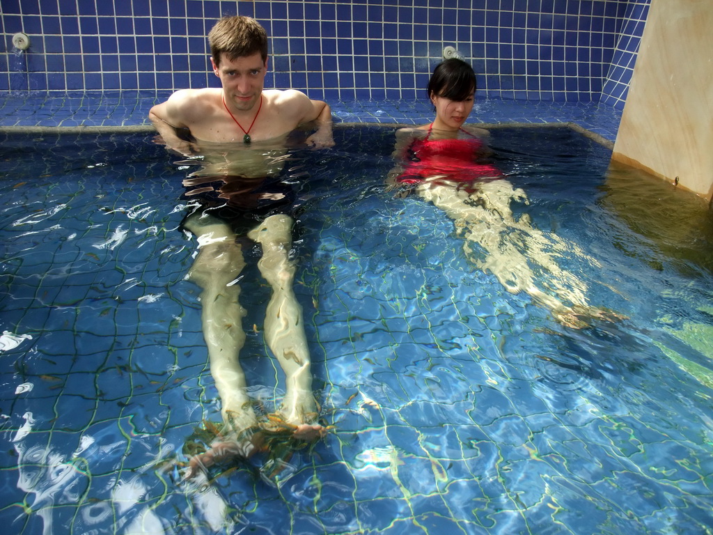 Tim and Mengjin with little fish in the Dr. Fish pool at the Fisherman`s Wharf at the Ocean Sonic Resort