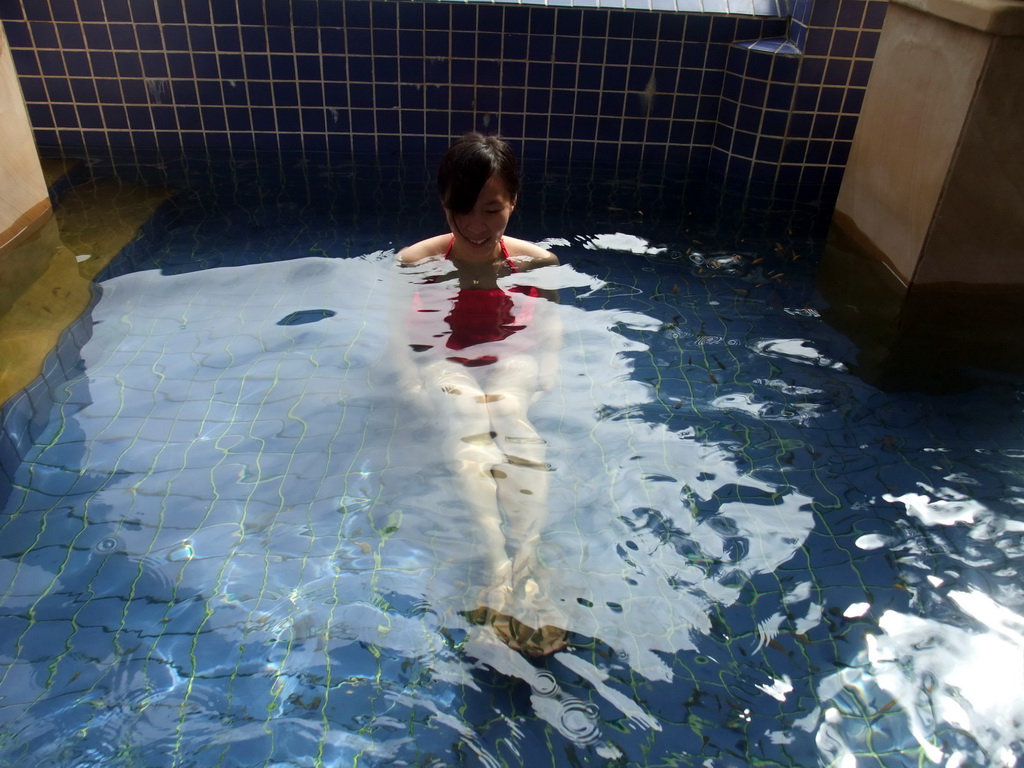 Mengjin with little fish in the Dr. Fish pool at the Fisherman`s Wharf at the Ocean Sonic Resort