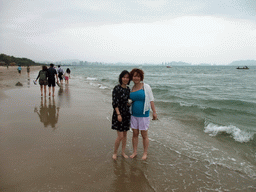 Miaomiao and Mengjin at the beach in front of the Ocean Sonic Resort, with a view on the skyline of Sanya