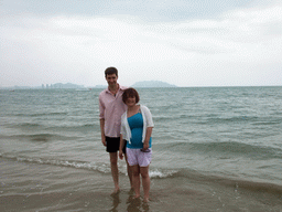 Tim and Miaomiao at the beach in front of the Ocean Sonic Resort, with a view on the skyline of Sanya
