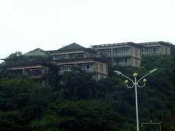 Houses on a hill near Miaojing, viewed from the car on the G98 Hainan Ring Road Expressway