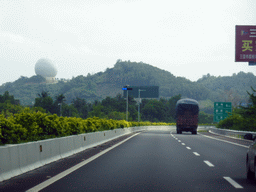 Hill with spherical building at the G98 Hainan Ring Road Expressway near Yingzhou, viewed from the car
