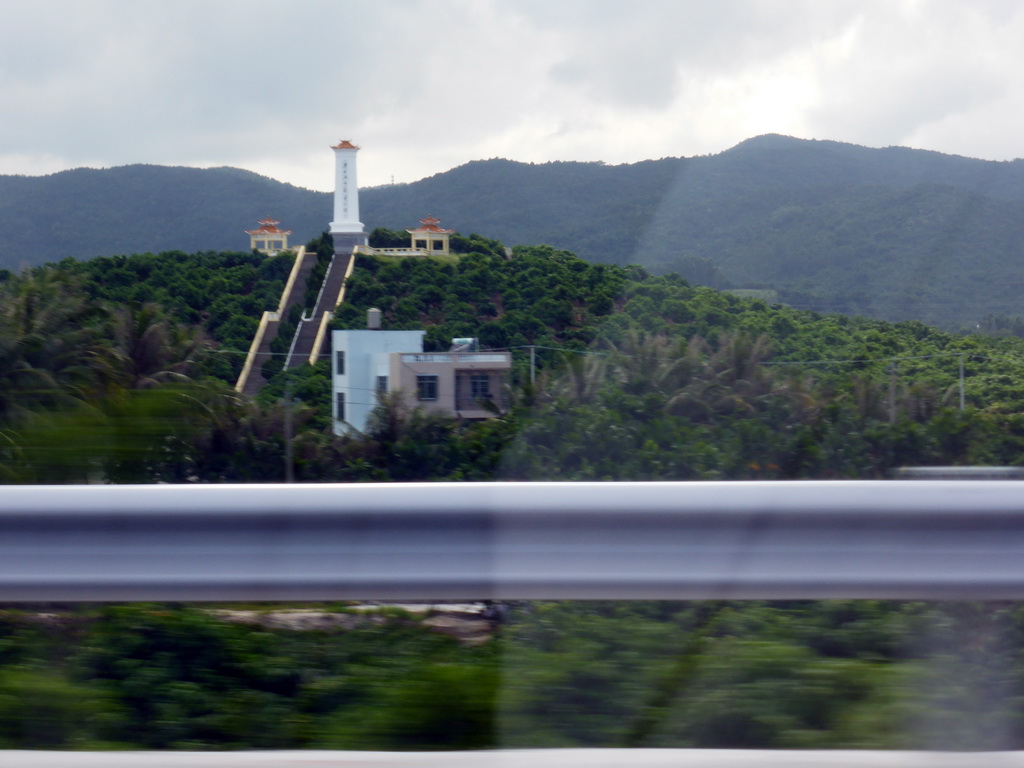 Hill with temple at the G98 Hainan Ring Road Expressway near Haitang Bay, viewed from the car