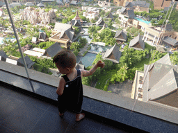 Max on the balcony of our room at the Sanya Bay Mangrove Tree Resort, with a view on the central area with the Amazon Jungle Water Park