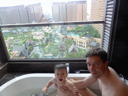 Tim and Max in the bathtub in our bathroom at the Sanya Bay Mangrove Tree Resort, with a view on the central area with the Amazon Jungle Water Park