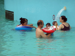 Miaomiao, Max and Miaomiao`s family at the swimming pool of the Amazon Jungle Water Park at the central area of the Sanya Bay Mangrove Tree Resort