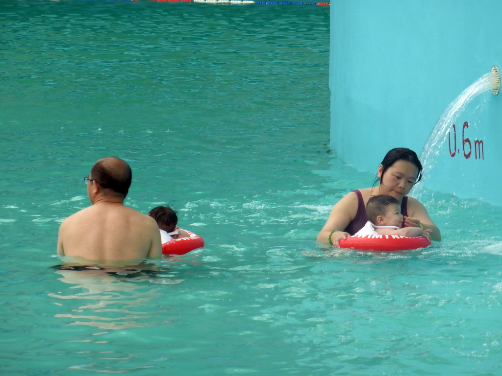 Miaomiao, Max and Miaomiao`s family at the swimming pool of the Amazon Jungle Water Park at the central area of the Sanya Bay Mangrove Tree Resort