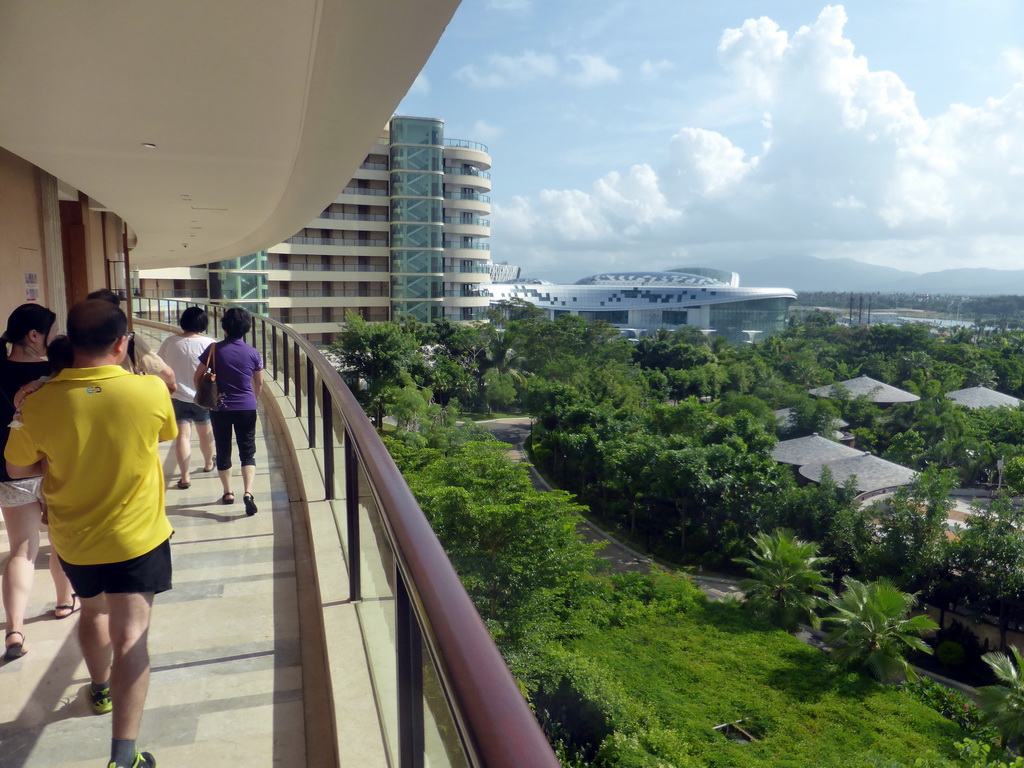 Miaomiao and her family on the walkway to their rooms at the InterContinental Sanya Haitang Bay Resort, with a view on the Sanya Begonia Bay International Shopping Centre and surroundings