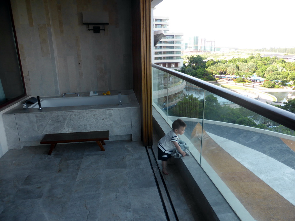 Max and the bathtub on the balcony of our room at the InterContinental Sanya Haitang Bay Resort