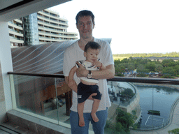 Tim and Max on the balcony of our room at the InterContinental Sanya Haitang Bay Resort, with a view on the pond and garden