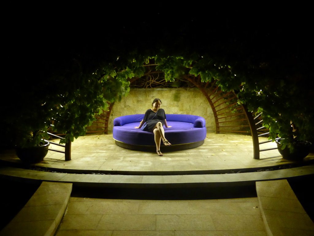 Miaomiao at a patio in the garden of the InterContinental Sanya Haitang Bay Resort, by night