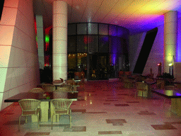 Tables and seats at the bar at the top floor of the InterContinental Sanya Haitang Bay Resort, by night