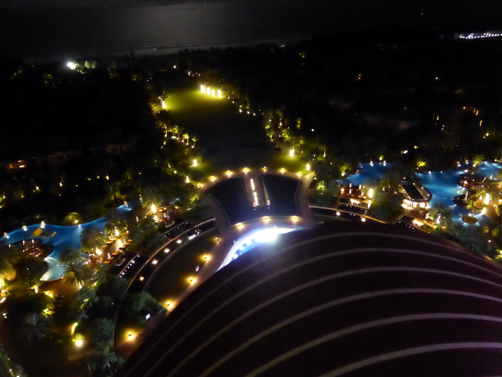 Swimming pool, garden and beach of the InterContinental Sanya Haitang Bay Resort, viewed from the top floor, by night