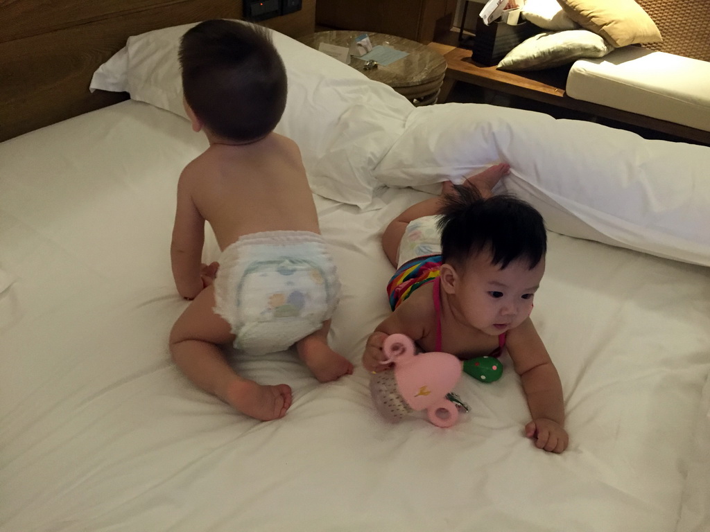 Max and his cousin on the bed in a room of the InterContinental Sanya Haitang Bay Resort