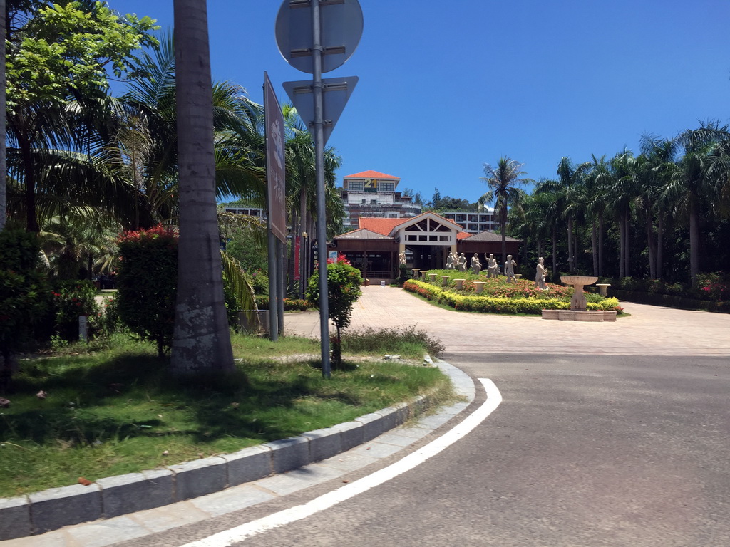 Road with statues, viewed from the car on the way back to Haikou