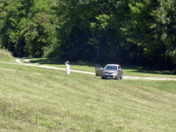 Miaomiao and our rental car in a grassland at the town of Monieux