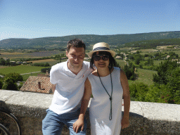 Tim and Miaomiao at the La Promenade square, with a view on the countryside to the west of the town