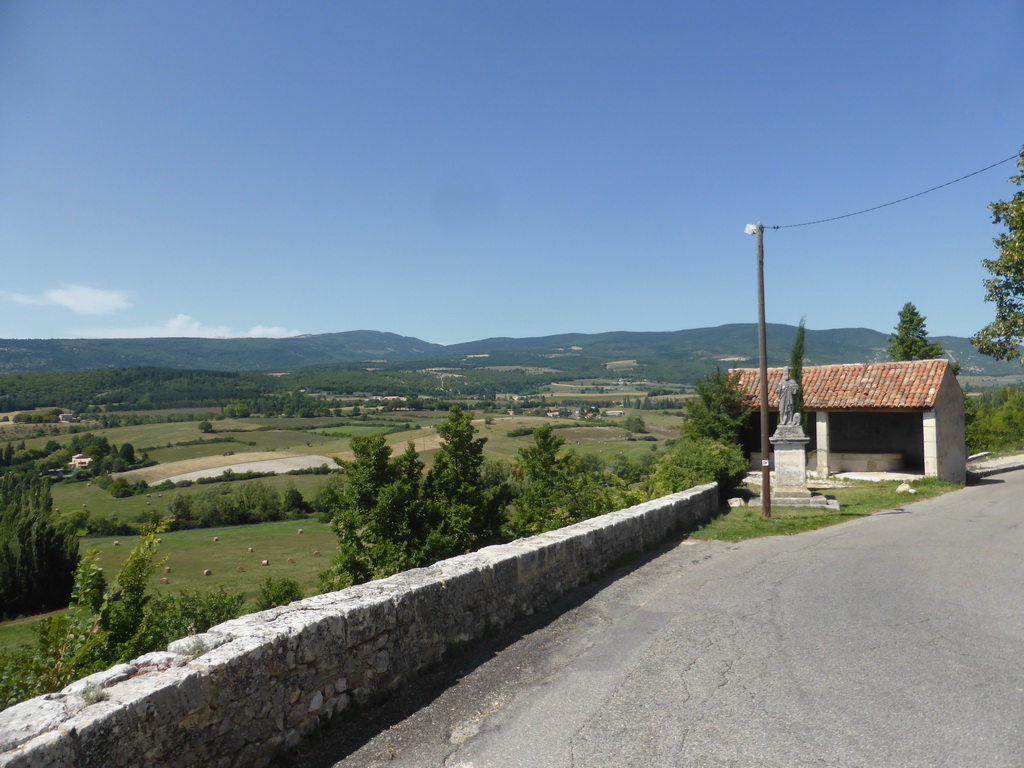 Statue at the Rue de l`Hôpital and a view on the countryside to the northwest of the town