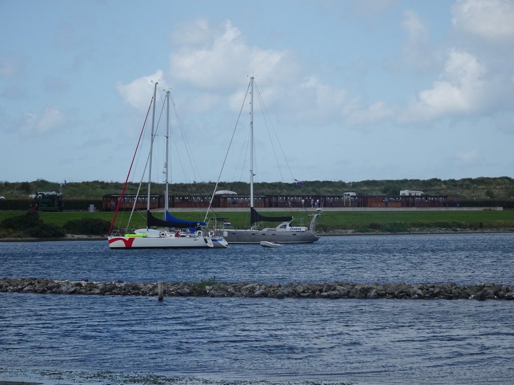 Steam train at the Brouwersdam and boats in the Grevelingenmeer lake, viewed from the West Repart beach