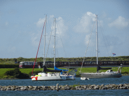 Old train at the Brouwersdam and boats in the Grevelingenmeer lake, viewed from the West Repart beach