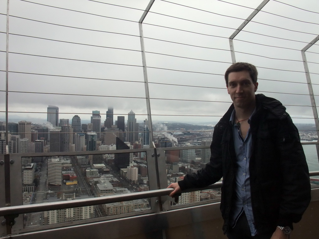 Tim with the skyline of Seattle, at the observation deck of the Space Needle